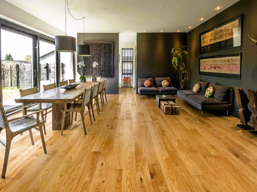 Modern living room with wooden floors, dining table, and stylish furniture. Bright and spacious.